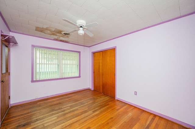 spare room with ornamental molding, hardwood / wood-style floors, and ceiling fan
