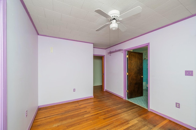 spare room with ceiling fan, ornamental molding, and hardwood / wood-style floors