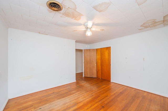 spare room featuring ceiling fan and light hardwood / wood-style floors