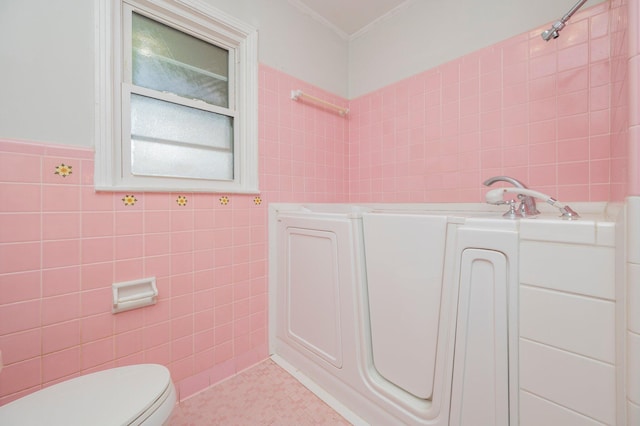 bathroom with crown molding, tile walls, tile patterned flooring, a bath, and toilet