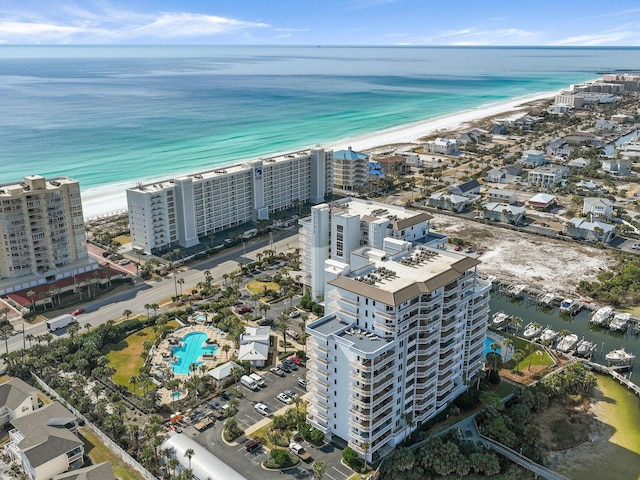 drone / aerial view featuring a water view and a view of the beach