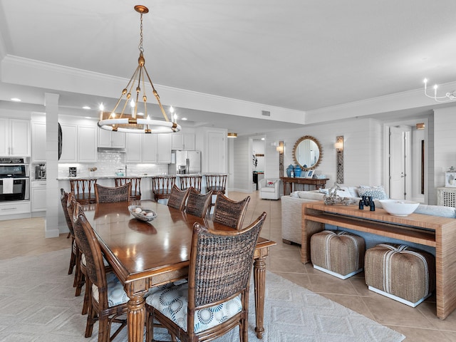 dining area featuring ornamental molding and light tile patterned floors