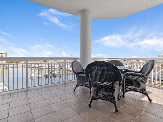 view of patio / terrace featuring a balcony and a water view