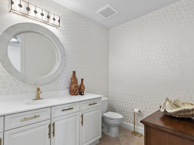 bathroom with vanity, tile patterned flooring, and toilet