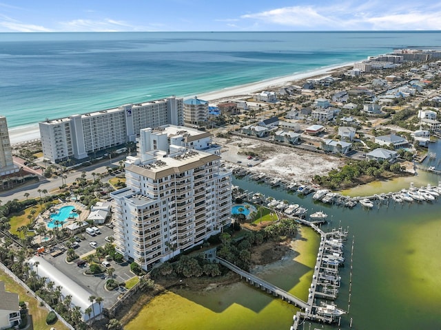 drone / aerial view featuring a water view and a view of the beach