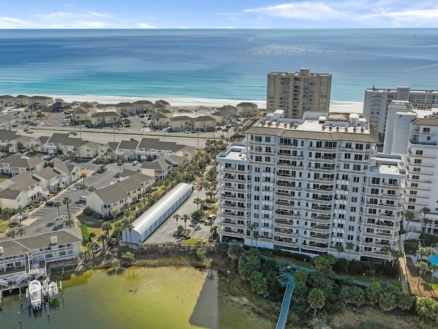 bird's eye view with a water view and a beach view