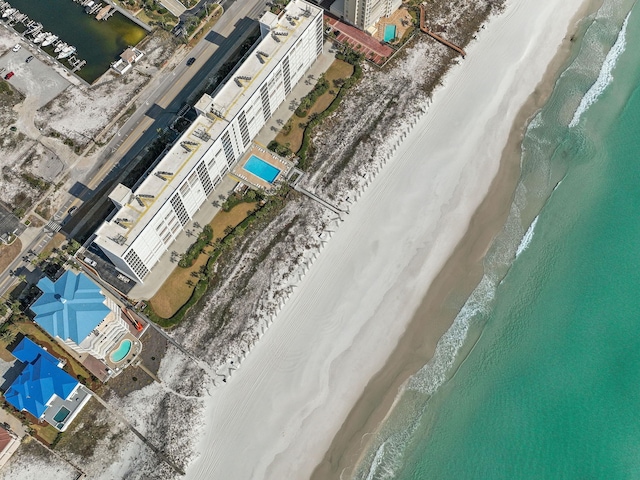 drone / aerial view featuring a water view and a beach view