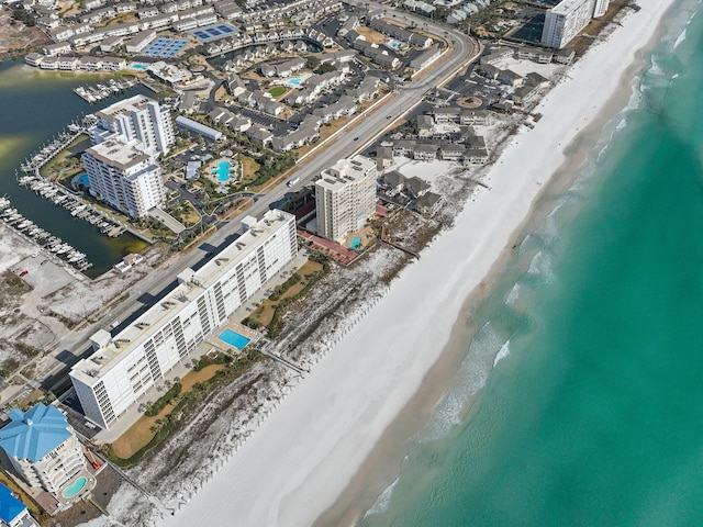 bird's eye view with a water view and a beach view