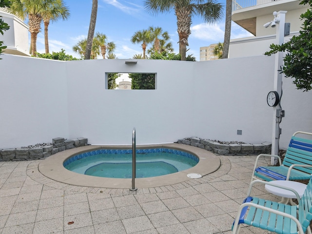 view of pool with an in ground hot tub and a patio