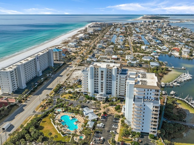 drone / aerial view featuring a beach view and a water view