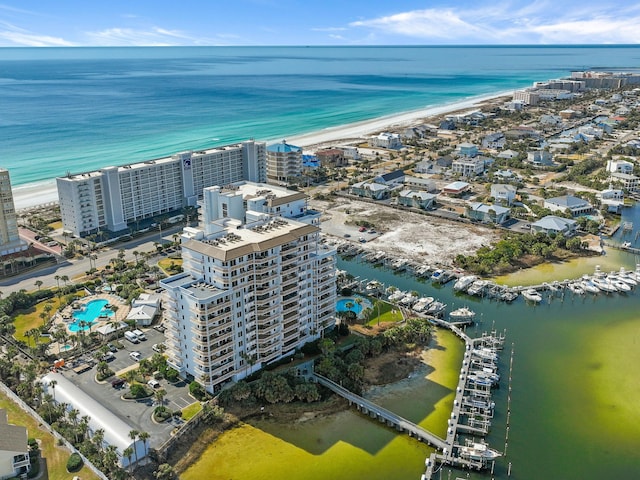 drone / aerial view with a water view and a beach view