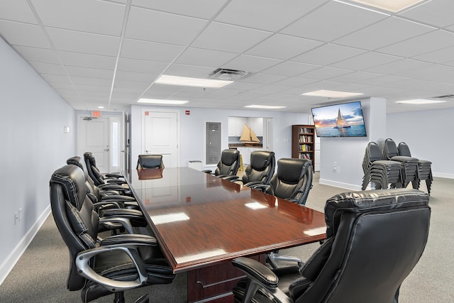 office space with a paneled ceiling and carpet