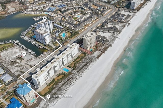 drone / aerial view featuring a water view and a beach view