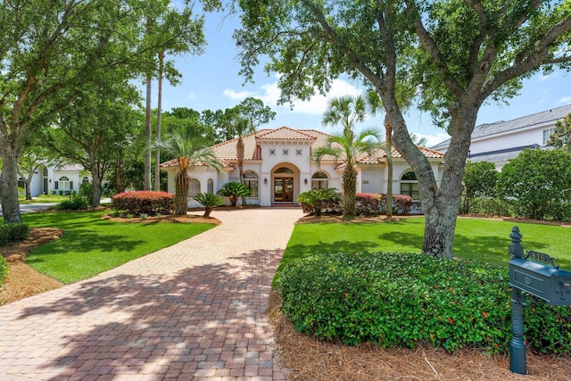 416 Admiral Ct, Destin, FL 32541 - mediterranean / spanish-style house featuring french doors, a tile roof, decorative driveway, a front lawn, and stucco siding
