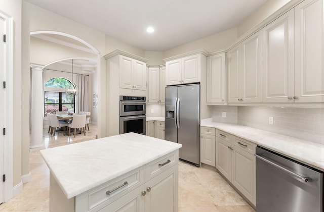416 Admiral Ct, Destin, FL 32541 - kitchen with appliances with stainless steel finishes, backsplash, decorative columns, light countertops, and recessed lighting