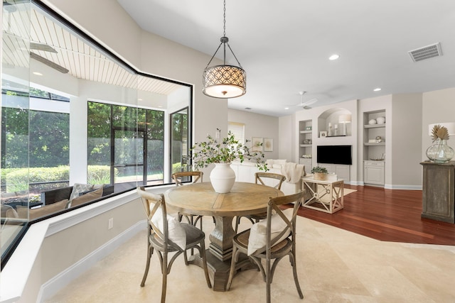 416 Admiral Ct, Destin, FL 32541 - dining space with built in features, a ceiling fan, baseboards, and light wood-style floors