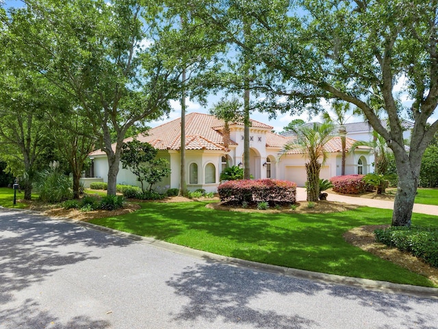 416 Admiral Ct, Destin, FL 32541 - mediterranean / spanish-style home with a tile roof, a garage, driveway, a front lawn, and stucco siding