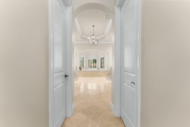 416 Admiral Ct, Destin, FL 32541 - hall featuring arched walkways, ornamental molding, and a chandelier