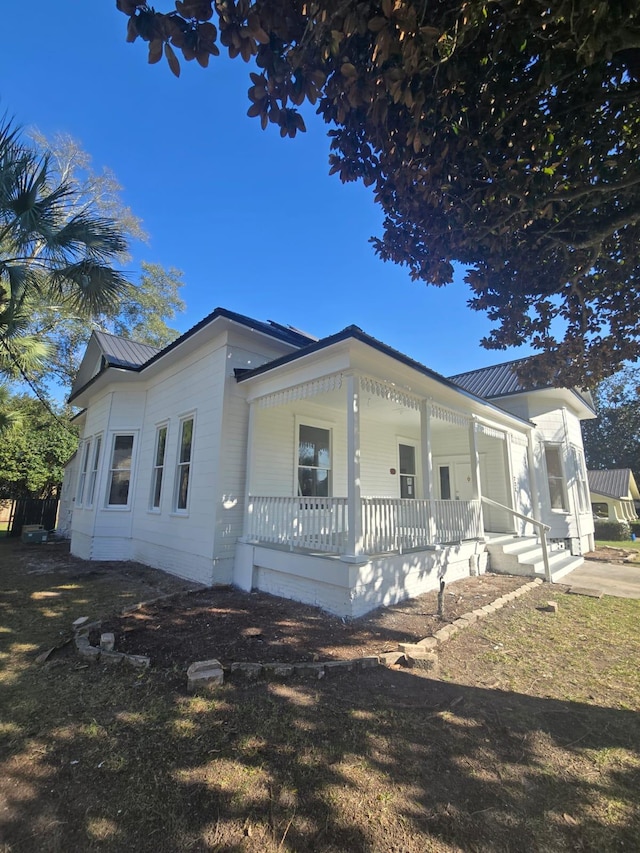 view of front of home featuring covered porch and metal roof