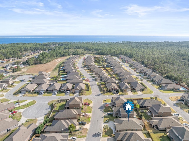 bird's eye view with a wooded view and a residential view