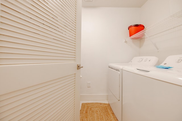 washroom with light tile patterned flooring and washer and clothes dryer