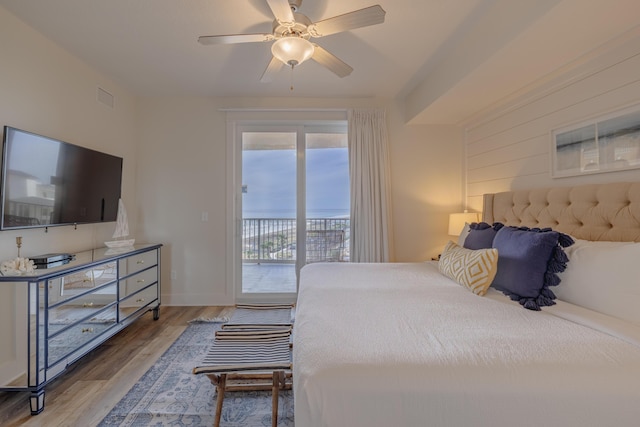 bedroom featuring ceiling fan, access to exterior, and hardwood / wood-style floors