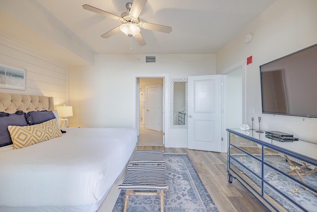 bedroom with ceiling fan and light hardwood / wood-style flooring