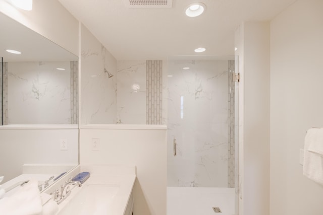 bathroom featuring vanity and tiled shower