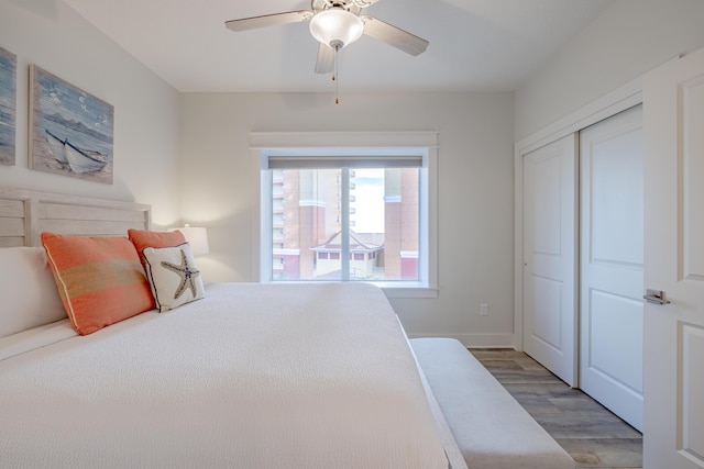 bedroom featuring ceiling fan, hardwood / wood-style floors, and a closet