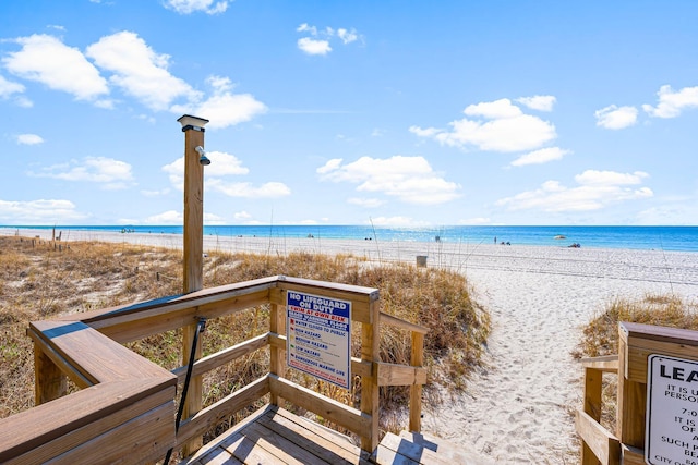 view of property's community featuring a view of the beach and a water view