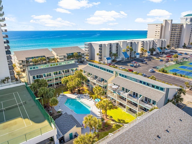 birds eye view of property with a water view and a beach view