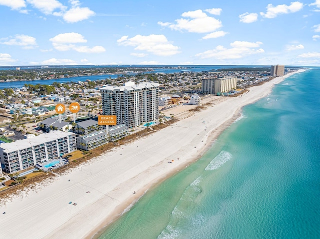 birds eye view of property with a view of the beach and a water view