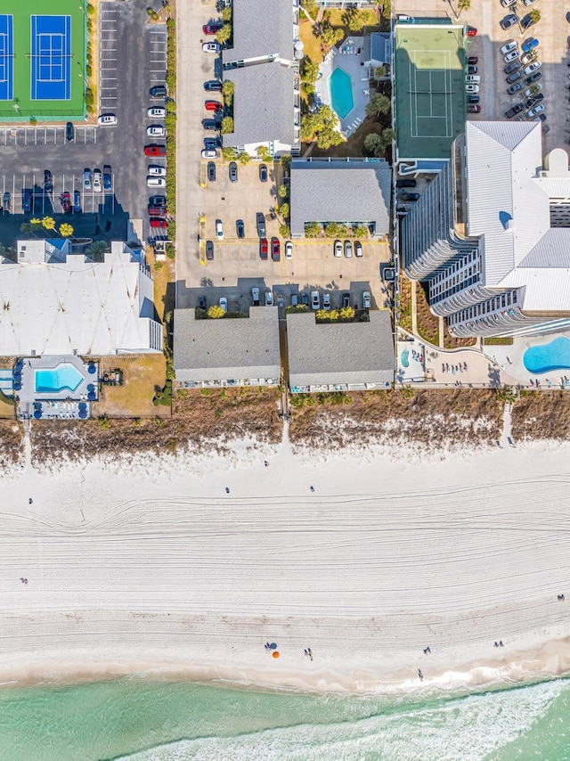 birds eye view of property featuring a water view and a view of the beach