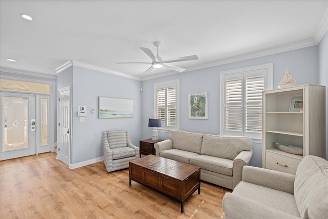 living room featuring crown molding, ceiling fan, and light hardwood / wood-style floors