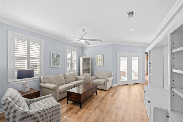 living room with crown molding, ceiling fan, and light wood-type flooring