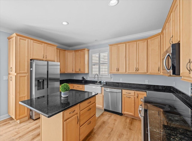 kitchen featuring a kitchen island, appliances with stainless steel finishes, sink, dark stone counters, and crown molding