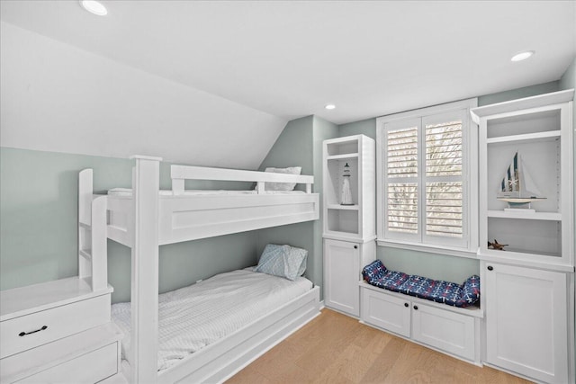 bedroom featuring vaulted ceiling and light hardwood / wood-style flooring