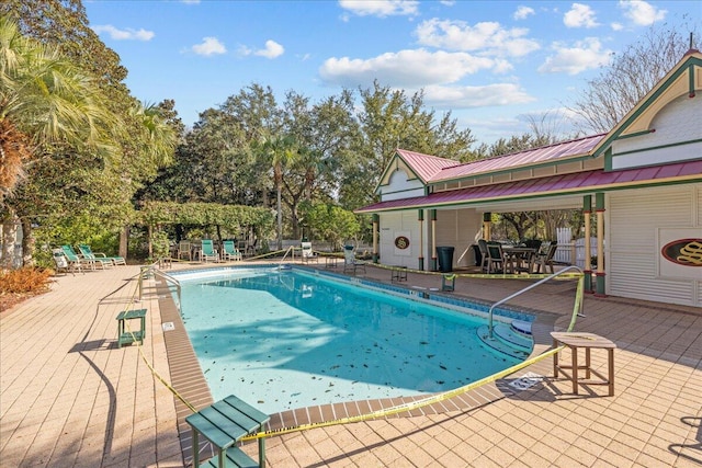 view of swimming pool featuring a patio area