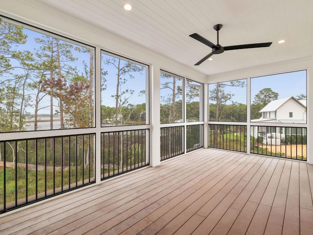 unfurnished sunroom featuring ceiling fan and wooden ceiling