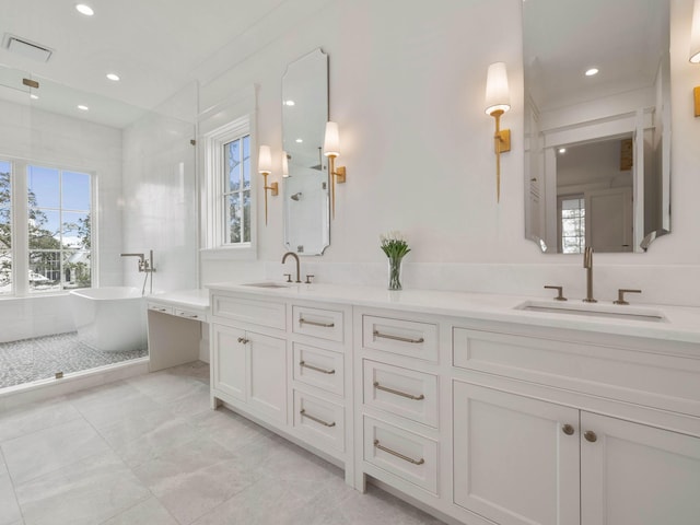 bathroom with vanity, separate shower and tub, and a healthy amount of sunlight