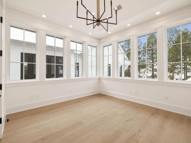 unfurnished sunroom featuring an inviting chandelier