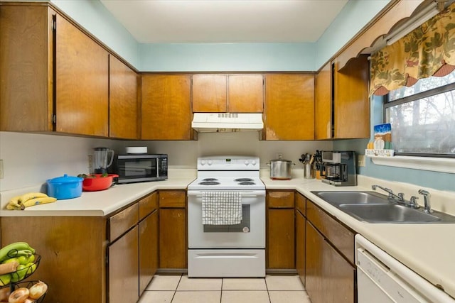 kitchen featuring sink, white appliances, and light tile patterned floors