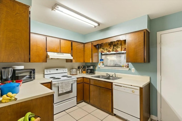 kitchen featuring white appliances, sink, and light tile patterned floors