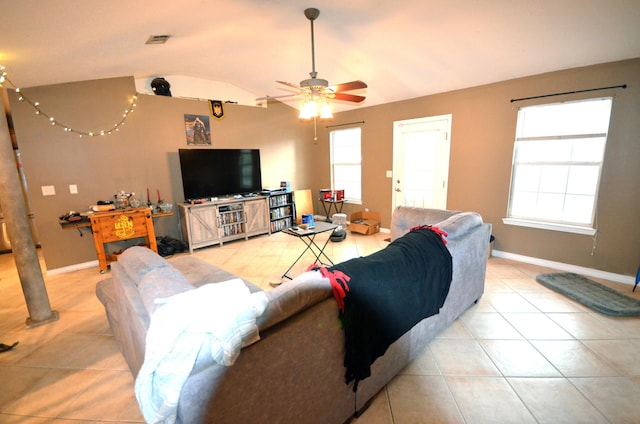 living room with light tile patterned floors, vaulted ceiling, and ceiling fan