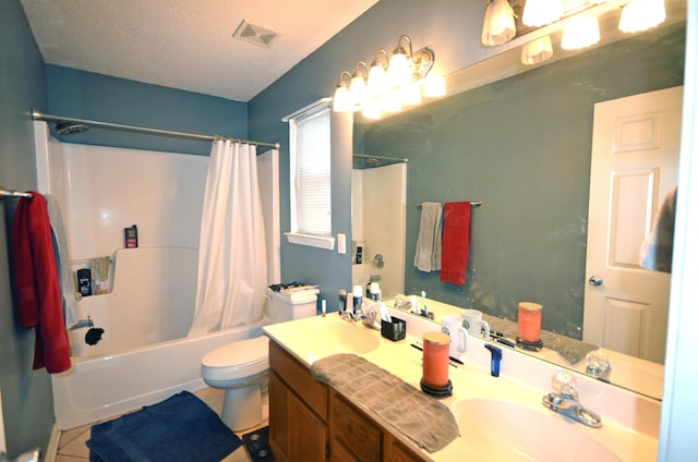 full bathroom with shower / tub combo, vanity, a textured ceiling, tile patterned floors, and toilet