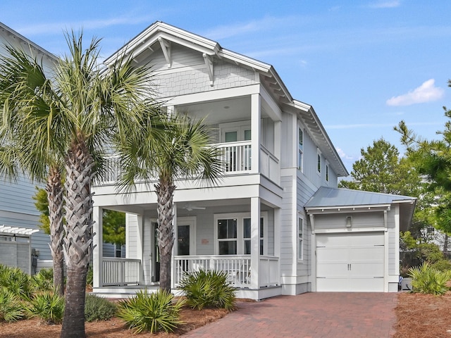 view of front of house featuring a garage, a balcony, and a porch