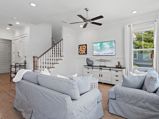 living room featuring crown molding, ceiling fan, and light wood-type flooring