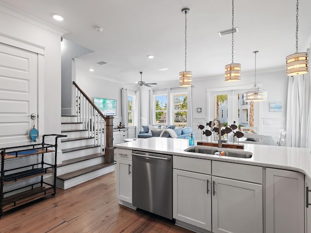 kitchen featuring ornamental molding, dishwasher, sink, and hanging light fixtures