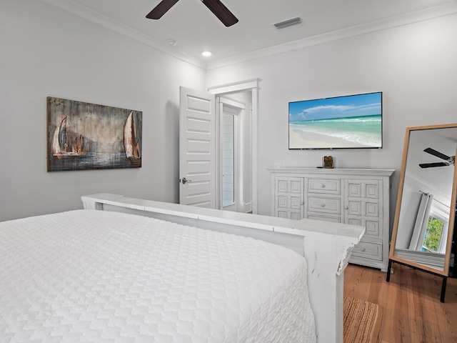 bedroom featuring crown molding, ceiling fan, and hardwood / wood-style floors