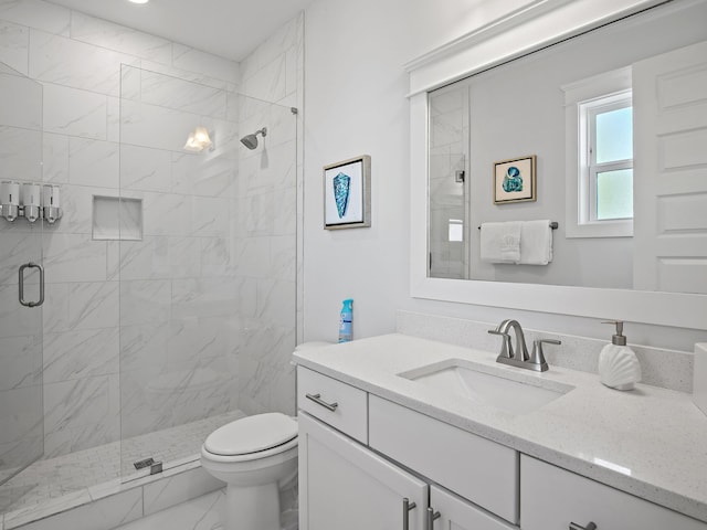 bathroom featuring vanity, toilet, and walk in shower